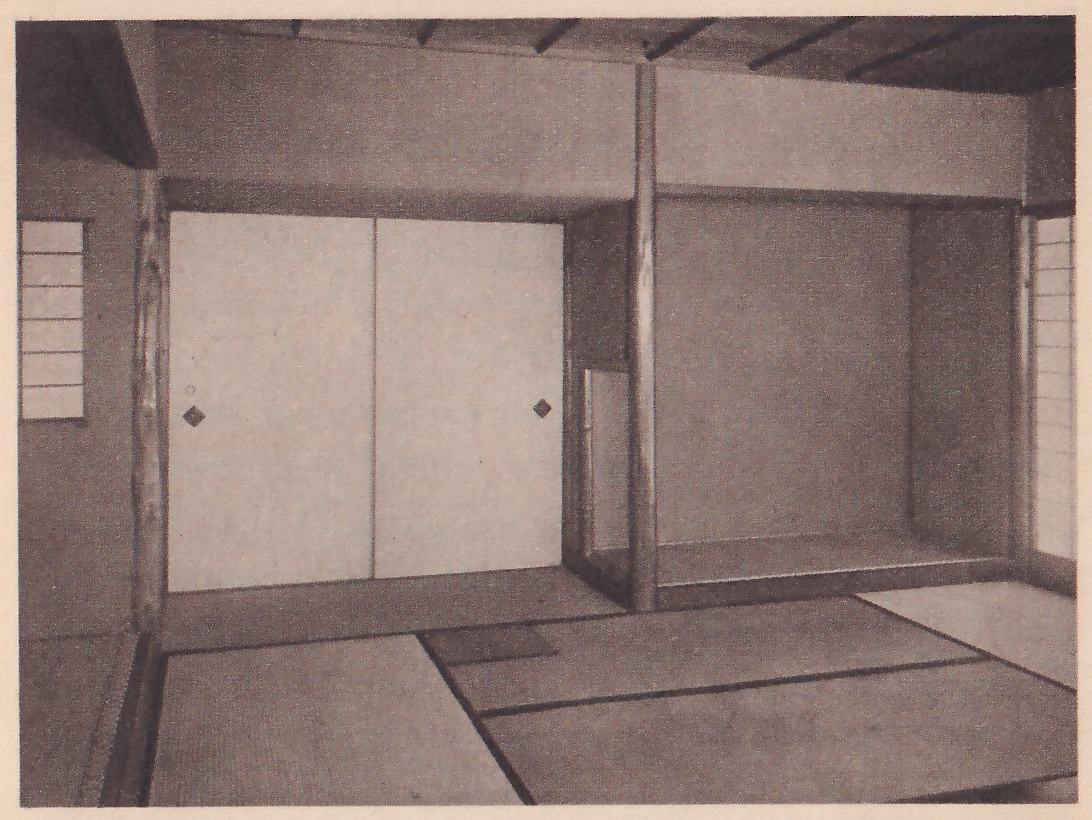 Photograph of two alcoves side by side in a bare mat room under a low ceiling of crossed boards: at the left a wall with two sliding doors, a round tree post in the middle, and at the right a deep empty alcove with a window beside it.