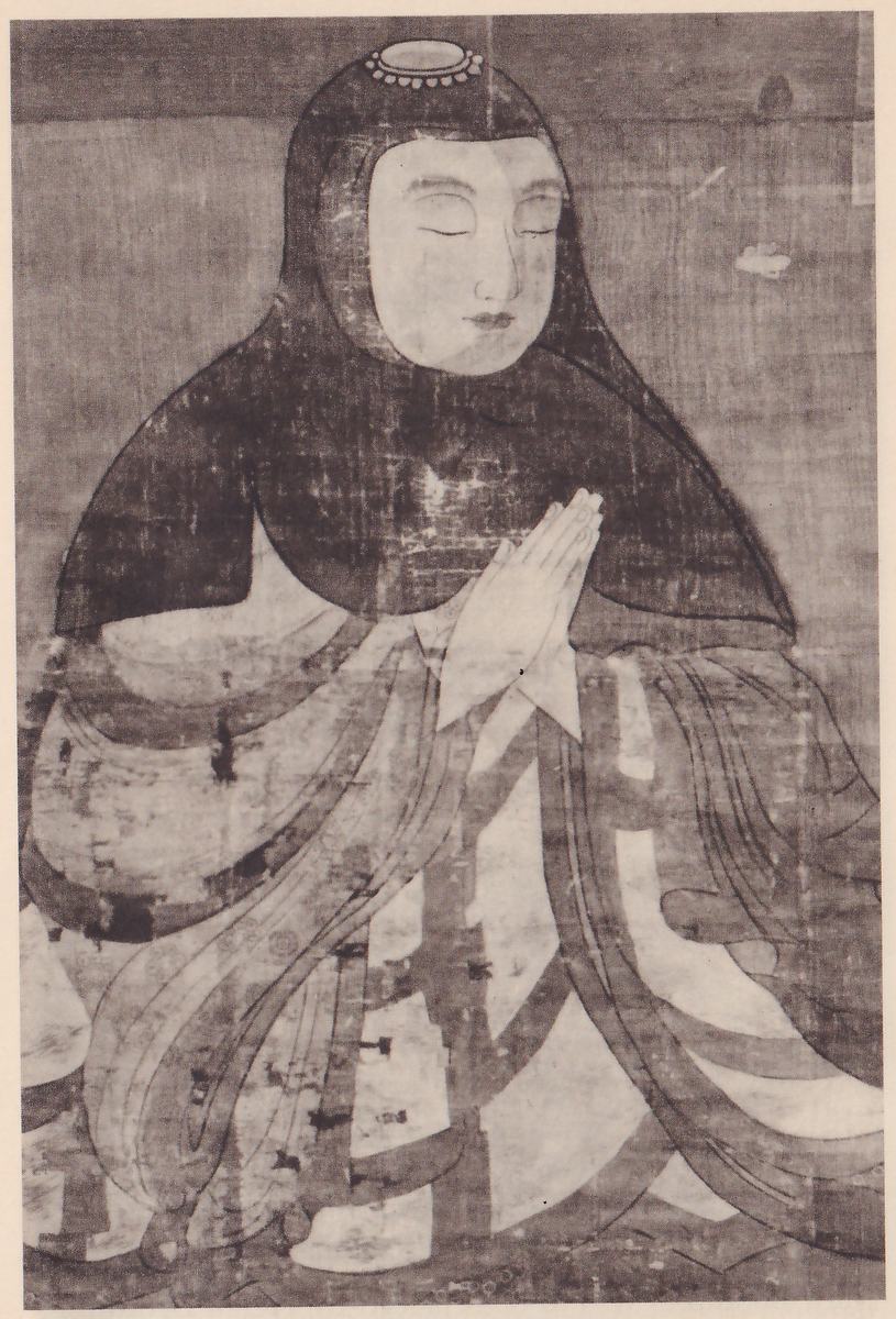 Faded painting of a figure from the chest up in a dark close-fitting hood with a small round ornament at the top, a pale face with lowered eyes, and hands pressed together in front of the chest; the wide robes below are in pale and dark bands.
