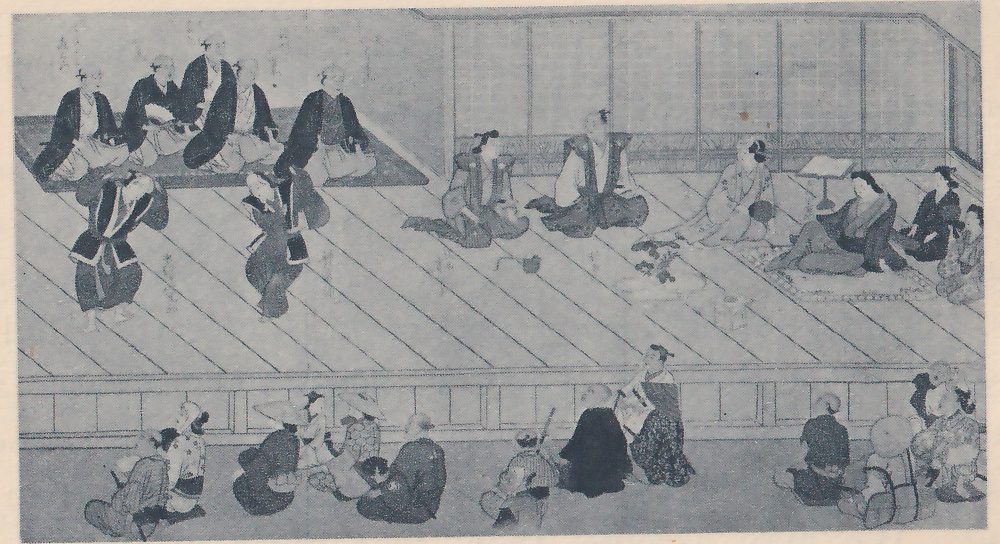 Painting of a wide floor of diagonal planks seen from a little above, backed by sliding screens. At the upper left a group of men in dark robes kneel on a dark mat, and in front of them two people in dark robes stand with their arms raised. At the center rear people kneel and one sits upright in a dark jacket; at the right a person reclines with an arm propped near a book on a stand, with more people on a mat beside them. A low railing runs across the foreground, and a crowd of people in robes sits on the ground in front of it.