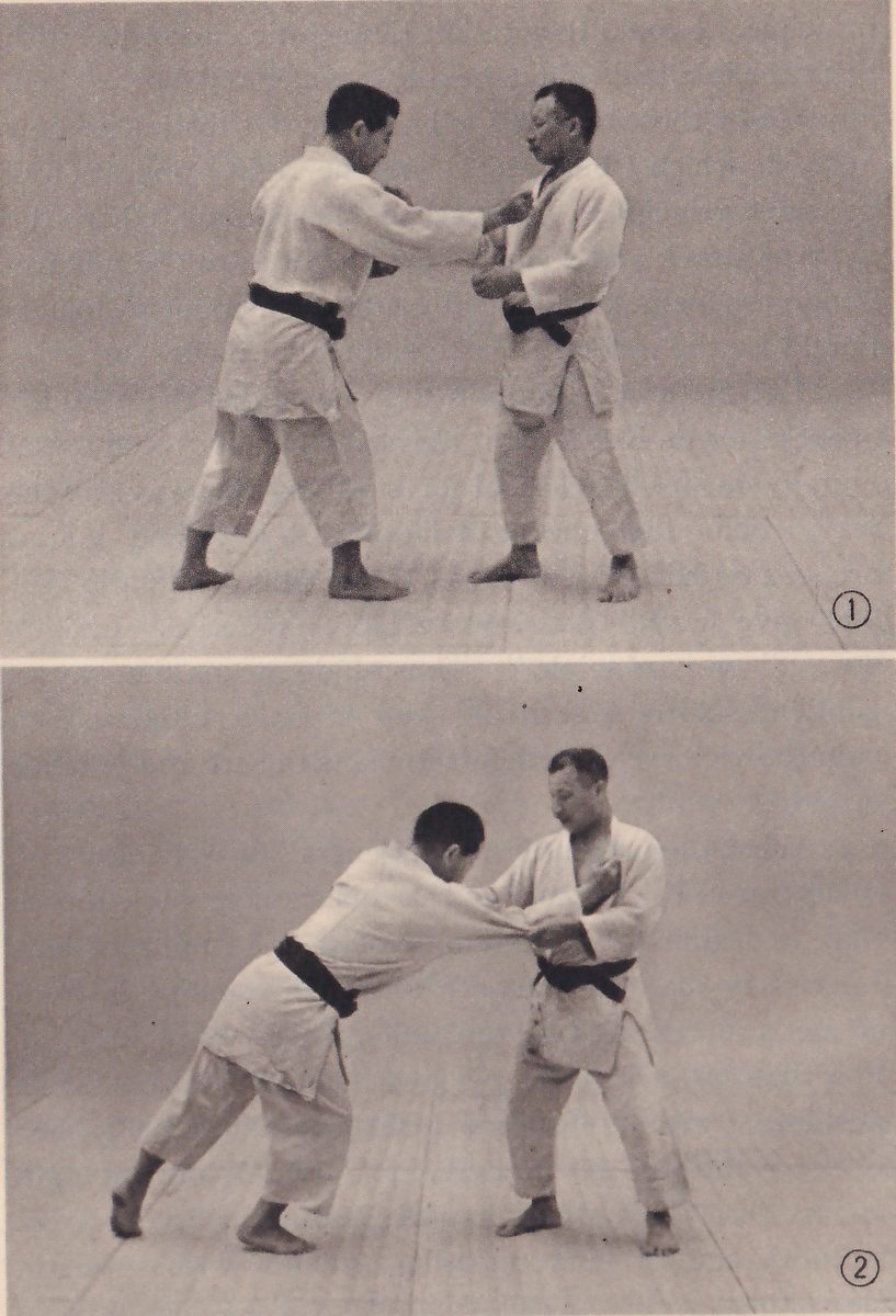 Two photographs, one above the other, numbered 1 and 2 in circles. In 1 two men in judo suits stand facing each other, the one on the left reaching out to push. In 2 the man on the left leans far forward with both hands on the other's chest while the man on the right has stepped back and stands upright.