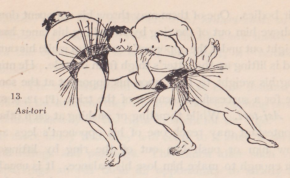 Line drawing of two wrestlers, each in a dark belt with an apron of hanging strands. The two men tangle at the center. One is bent forward at the upper left with a topknot at the top left corner. The other, his face turned downward at the upper center, leans across him with one arm raised, his legs bent and spread to the lower left and the lower right. Printed beside the drawing: 13. Asi-tori