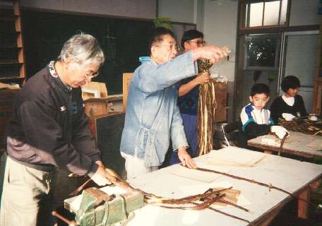 Stripping the white bark from the black