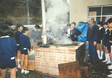 Students watch as the kozo is dyed